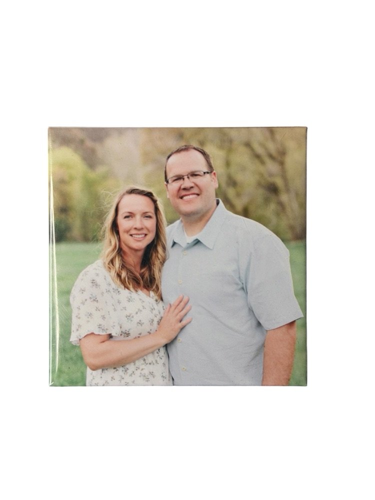 Custom photo magnet of an engaged couple in a green field